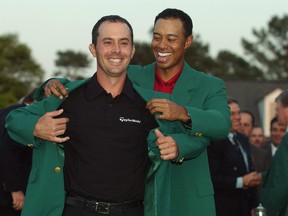 Mike Weir of Bright's Grove is presented with the green jacket by Tiger Woods after winning the playoff after the final round of the 2003 Masters Tournament at the Augusta National Golf Club in Augusta, Georgia on April 13, 2003. (Photo by Harry How/Getty Images)