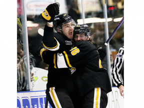 Sarnia Sting players Nolan Dillingham (18) celebrates with Ty Voit (96) after scoring in the first period against the Guelph Storm in Game 1 of their OHL second-round series at Progressive Auto Sales Arena in Sarnia on Friday, March 31, 2023. (Mark Malone/Postmedia Network)