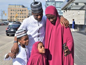 A family gathers for a selfie before heading inside RBC Place to celebrate Eid al-Fitr, the holy day marking the end of Ramadan's month of fasting. Photo taken on Friday April 21, 2023. (Calvi Leon/The London Free Press)