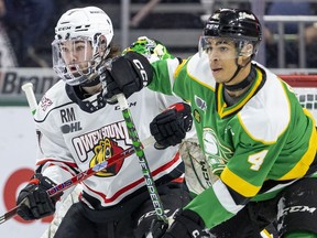 Isaiah George of the London Knights tries to keep Deni Goure of the Owen Sound Attack from the front of the net screening Brett Brochu during Game One of their OHL first-round playoff game at Budweiser Gardens on Friday March 31, 2023. The Knights won, 7-0. 
Mike Hensen/The London Free Press
