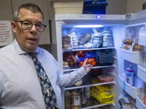 Jeff Holbrough, principal at London's J. P. Robarts elementary school, shows a fridge full of food paid for in part by the Ontario school nutrition program and President's Choice. The school hands out out 70 to 80 bagels a day to pupils representing 25 to 30 per cent of the school's population, he estimates, and the daily lunch program offers fruit, cheese snacks and yogurt in classroom treat boxes. (Mike Hensen/The London Free Press)