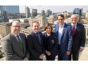 London Mayor Josh Morgan and Middlesex County Warden Cathy Burdghardt-Jesson are flanked by provincial politicians Steve Clark, left, and Monte McNaughton and Rob Flack to the right. They were photographed atop city hall on Tuesday April 25, 2023. (Mike Hensen/The London Free Press)