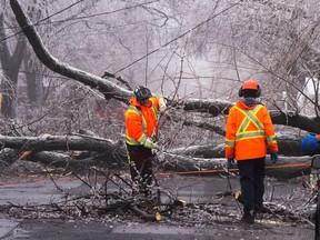 City workers clears fallen branches Thursday, April 6, 2023 after yesterday?s ice storm which left over a million customers without power in Montreal.