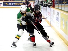 Ryan Winterton and Colby Barlow battle for the puck as the Owen Sound Attack host the London Knights in Game 4 of their Western Conference quarterfinal series on Thursday, April 6, 2023. Greg Cowan/The Sun Times