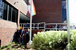 Mark Fisher, left, education director of the Thames Valley District school board, and board chair Lori-Ann Pizzolato raise a progress pride flag at board headquarters in London on Wednesday, May 17, 2023, to mark the International Day Against Homophobia, Transphobia and Biphobia. (Derek Ruttan/The London Free Press)