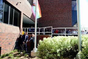 Mark Fisher, left, education director of the Thames Valley District school board, and board chair Lori-Ann Pizzolato raise a progress pride flag at board headquarters in London on Wednesday, May 17, 2023, to mark the International Day Against Homophobia, Transphobia and Biphobia.  (Derek Ruttan/The London Free Press)