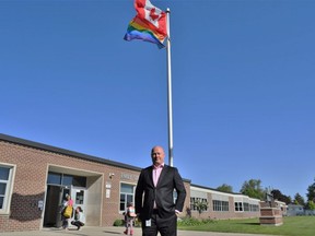 Dennis Wright, Thames Valley District school board superintendent of safe schools and well-being, stands in front of a Pride flag raised outside Emily Stowe elementary school in Norwich Township on Wednesday, May 17, 2023 to mark international day against homophobia, biphobia and transphobia. (Calvi Leon/The London Free Press)
