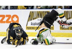 Ryan Humphrey of the London Knights flips over a fallen Sasha Pastujov of the Sarnia Sting during Game 3 of their OHL Western Conference championship series in Sarnia on Tuesday May 2, 2023. Mike Hensen/The London Free Press