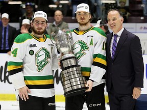 London Knights co-captains George Diaco, left, and Sean McGurn receive the Wayne Gretzky Trophy from Ontario Hockey League vice-president Ted Baker after beating the Sarnia Sting in Game 6 of the OHL's Western Conference final at Progressive Auto Sales Arena in Sarnia on Sunday, May 7, 2023. The Knights are off to the league final against North Bay or Peterborough. Mark Malone/Sarnia Observer