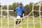 A Green Rise Foods player is pictured through a hole in the net during a pre-game practice at the second annual Greenhouse Cup soccer tournament for migrant workers at the Leamington Soccer Complex in Leamington on Sunday, May 28, 2023. (Mark Malone/ Postmedia Network)