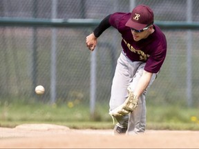 Shane Moritz of the Banting Broncos fields a ball hit by a Laurier Rams player during their TVRA co-ed high school baseball game at Aldridge Field in London on Tuesday May 16, 2023. (Derek Ruttan/The London Free Press)