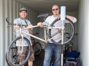 Shawn Mitchell, left, and A.J. McCallum are fixing up bicycles at St Aidan’s Anglican Church in London. The church’s Bikes for Migrants campaign donates bikes to local migrant workers. Photo taken Tuesday, May 23, 2023. (Derek Ruttan/The London Free Press)