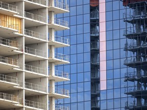 New construction on Talbot Street of Old Oak’s Centro building is reflected across the street in London.  The London census metropolitan area has the nation's second highest job growth post-pandemic. (Mike Hensen/The London Free Press)