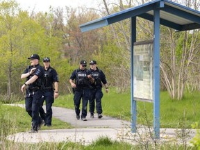 London police search Westminster Ponds in south London after a citizen reported seeing two men drag a woman into in the wooded area on Monday, May 8, 2023. (Mike Hensen/The London Free Press)