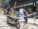 London Bicycle Café co-owner Andrew Hunniford pilots a cargo bike while holding 