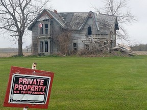 A Canadian flag attached to the second floor of the Guyitt House gently flaps in the wind on Tuesday May 2, 2023. The dilapidated structure in rural Chatham-Kent has been dubbed Canada's most photographed house. (Ellwood Shreve/ Postmedia)