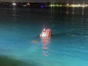 A woman has been charged with refusing to provide a breath sample, but there were no injuries after a car crashed into the St. Clair River near downtown Sarnia and sank, police say. It was removed soon after. (Twitter/Sarnia police)