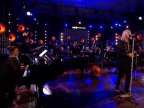 Singer-songwriter Emm Gryner performs with Def Leppard lead singer Joe Elliott in this screen shot of a BBC 2 performance of the band's classic single Pour Some Sugar On Me.