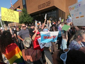 Demonstrators gather outside the Greater Essex County District school board meeting in Windsor on Tuesday, June 20, 2023.