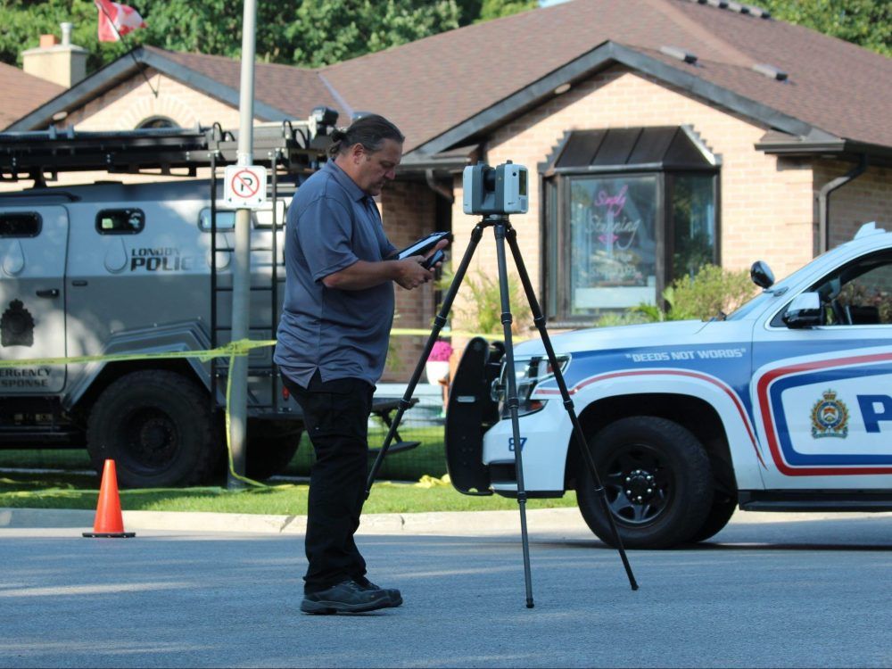 A member of the Special Investigations Unit collects evidence on July 21, 2023, outside of 66 Glenroy Rd. in London after London police fatally shot a 35-year-old man, who was a suspect in an attempted vehicle theft and shooting. (Dale Carruthers/The London Free Press)