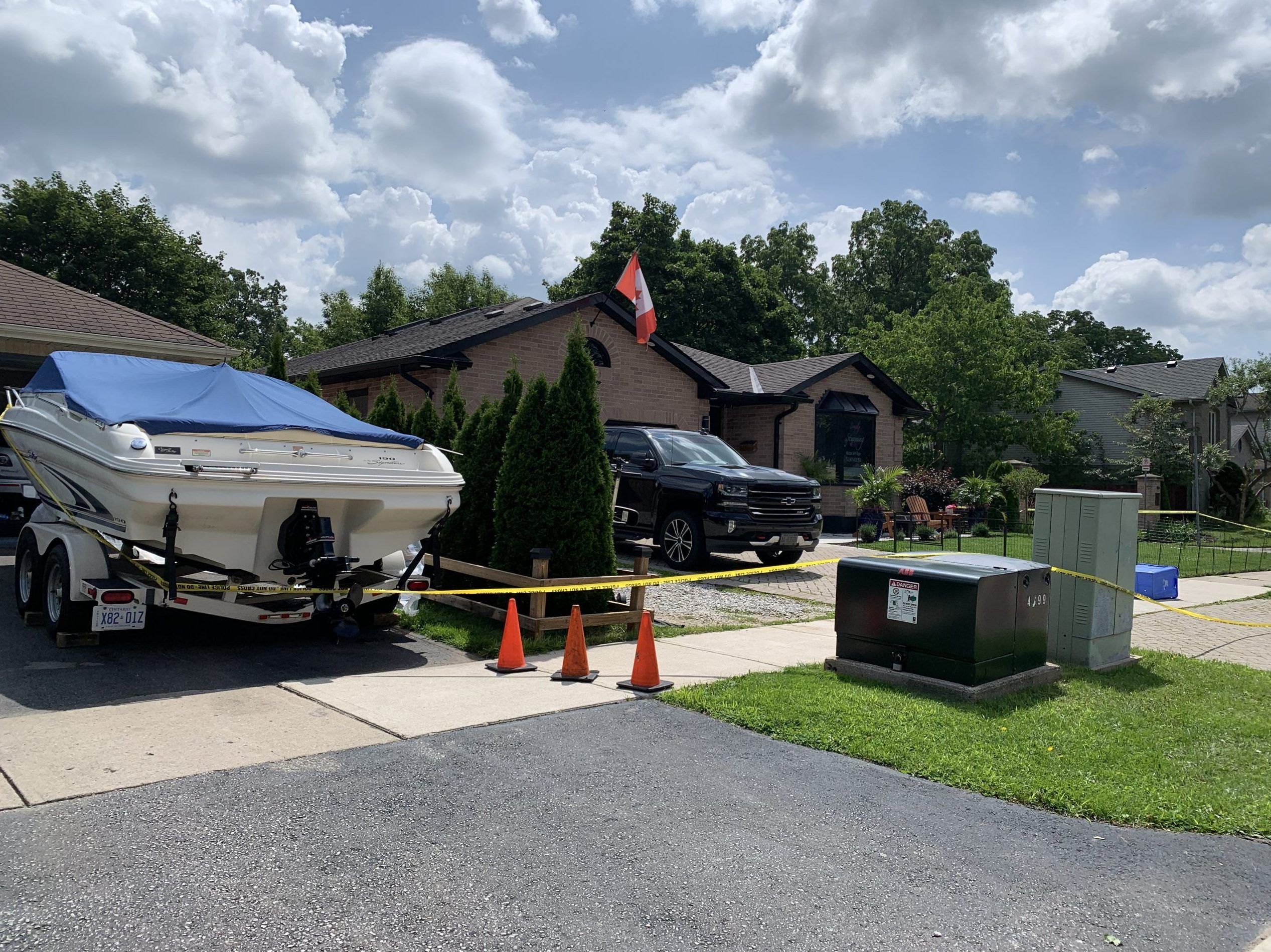 Yellow police tape surrounds a Glenroy Road home, and extends to the neighbour’s boat, in southeast London. It is where a man was shot dead by police two days prior. Photo taken on Sunday July 23, 2023. Jane Sims/ The London Free Press