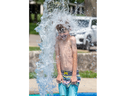 Seven-year-old Lucas Potts of St. Thomas gets soaked at the Rotary Club of St. Thomas Centennial Splash Pad in Pinafore Park in St. Thomas on Friday July 28, 2023. Derek Ruttan/ The London Free Press)