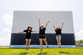 Katherine Hay, centre, jumps with her daughters Cassandra Hay, 14, and Megan Hay, 13, at the Oxford Drive-In that they now own west of Woodstock.Photograph taken on Tuesday, July 4, 2023. (Mike Hensen/The London Free Press)