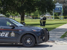 Brantford police officers investigate what they say was the non-suspicious death of an adult male in front of a daycare centre on Wednesday July 5, 2023. (Brian Thompson/ Postmedia)