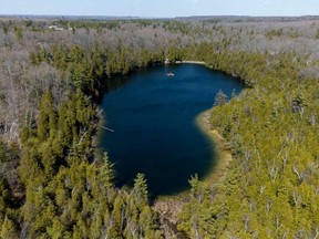 An aerial view of Crawford Lake as a team consisting of scientists from Carleton University and Brock University gather sediment layer samples from the lake bottom at the Crawford Lake Conservation Area near Milton, Ontario, Canada, April 12, 2023.