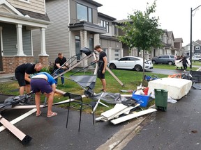 Families go outside near Merak Park to check out the damage to their homes and neighbourhood after a tornado ripped through Barrhaven in Ottawa on Thursday.