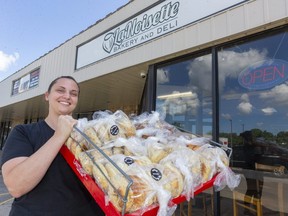 Tabitha Bartlett, one of the co-owners of La Noisette bakery at 900 Oxford St. East in London, holds up a tray of fresh bagels on Aug. 7, 2020. (Mike Hensen/The London Free Press)