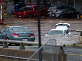 Abandoned cars in a mall parking lot are seen in floodwater following a major rain event in Halifax on July 22, 2023.