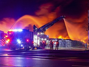 Firefighters battle a blaze Tuesday evening at North West Rubber on Henry Street in Brantford on Oct. 18, 2022. Brian Thompson/ Brantford Expositor