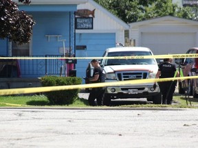 Sarnia police forensic investigators search for evidence at 222 Napier St. on Monday, Aug. 28, 2023, after an early morning shooting sent a man to hospital in London with serious injuries. (Tyler Kula/The Observer)
