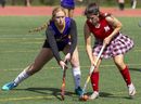 East Elgin's Mya Farr and Medway's Ava Donohue fight for the ball on Tuesday Sept. 19, 2023 in one of the first games of the high school athletic year, won by Medway 4-0.  Field hockey is trying out a two-tier system this year in a bid to cut down on lopsided scores, an official said.  (Mike Hensen/The London Free Press)
