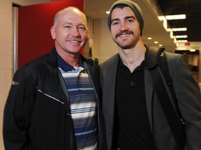 TJ Brodie, right, is shown with his dad, Jay, during his stint with the Calgary Flames on Nov. 28, 2013. (File photo)