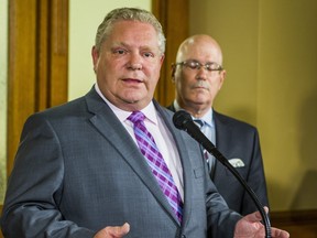 Ontario Premier Doug Ford and then Minister of Municipal Affairs and Housing Steve Clark address media outside of the premier's office at Queen's Park in Toronto, Ont. on Monday, May 27, 2019.