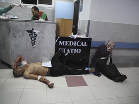 Palestinians wounded in Israeli strikes are brought to Shifa Hospital in Gaza City on Wednesday, Oct. 11, 2023.