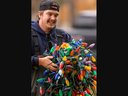 Nolan Vangeleuken of Oxford Tree Service carries a bundle of Christmas lights set to be hung in Victoria Park in downtown London for the Christmas season. Photo taken on Wednesday Nov. 22, 2024. Mike Hensen/The London Free Press