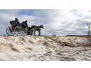 A family looks at the scene on Tuesday, Dec. 19, 2023, of a Monday crash between a horse-drawn buggy and a motor vehicle that killed a 13-year-old boy near Milverton, northeast of Stratford. (Mike Hensen/The London Free Press)