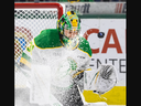 London Knights goalie Michael Simpson is hampered by snow as he tries to catch the puck during their OHL game against the Mississauga Steelheads at Budweiser Gardens in London on Friday December 1, 2023. The puck got past Simpson but hit the post and stayed out of the net. (Derek Ruttan/The London Free Press)
