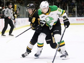 London Knights' Oliver Bonk (59) checks Sarnia Sting's Tyson Doucette (25) in the first period at Progressive Auto Sales Arena in Sarnia, Ont., on Wednesday, Jan. 10, 2024. Mark Malone/Chatham Daily News/Postmedia Network