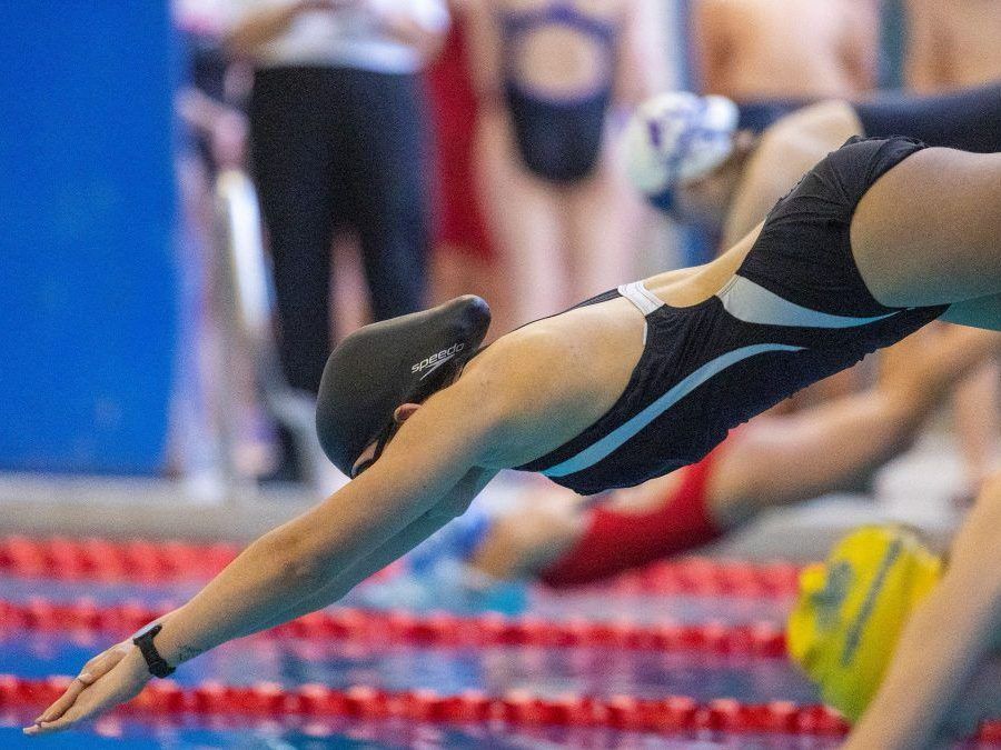 High school athletes dive into the water at the start of the girls 14 and under 50-metre short course breast stroke at a TVRA swim meet at the Canada Games Aquatic Centre in London on Wednesday, Jan. 10, 2024. (Mike Hensen/The London Free Press)