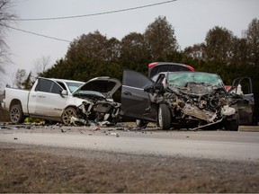 Officers with the OPP investigate a serious three-vehicle collision that claimed the lives of two people on County Road 34, west of Wheatley, on March 18, 2022.