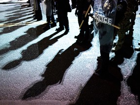 Police shields and shadows at activist protest