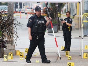 Windsor Police Service officers investigate the the morning after an execution-style slaying of a University of Windsor student at the downtown intersection of Ouellette and University avenues on Aug. 27, 2018. The evidence collected was shown jurors at a subsequent trial that led to a first-degree murder conviction.