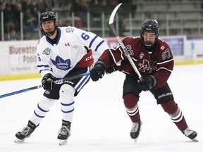 Chatham Maroons' Colton Henderson (97) and London Nationals' Brandon Scott (6) chase the puck at Chatham Memorial Arena in Chatham, Ont., on Sunday, Jan. 21, 2024. The Maroons’ post-holiday struggles continued Wednesday with a 6-2 road loss to the Nationals. (Mark Malone/Chatham Daily News)