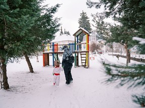 Mother and child walking towards playground