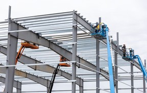 People work on a new building