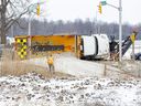 A snow plow spilled hundreds of kilograms of road salt after it tipped over while turning from Littlewood Drive onto Colonel Talbot Road in London on Friday, March 22, 2024. The driver was uninjured and was able to climb out of the vehicle without assistance. (Derek Ruttan/London Free Press)